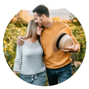 A happy couple embracing outdoors, reconnecting.