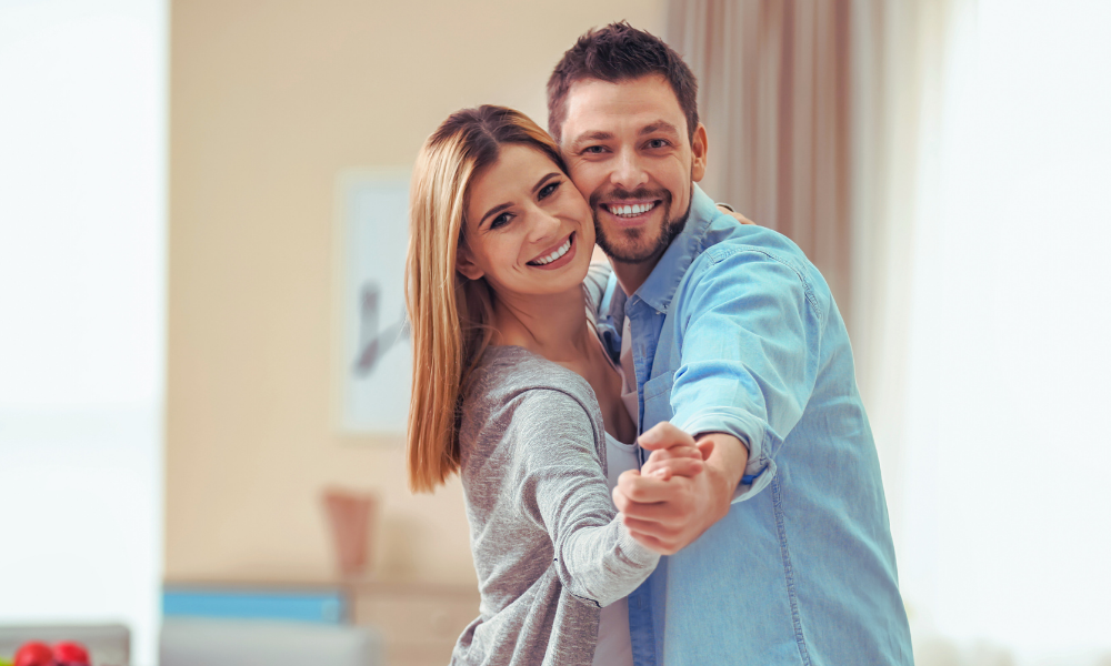 A couple dancing in their home