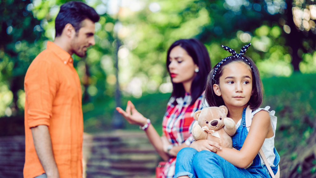 Parents talking with their child in the foreground
