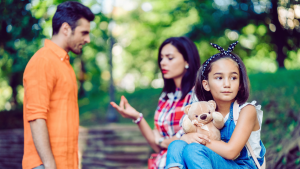 Parents talking with their child in the foreground